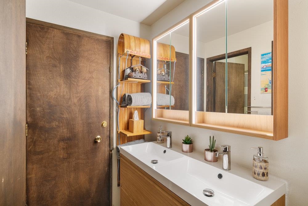 5659 Rhodesia Road Carnelian Bay, CA 96140 - Photo 16 of 28 a bathroom with a sink and a mirror