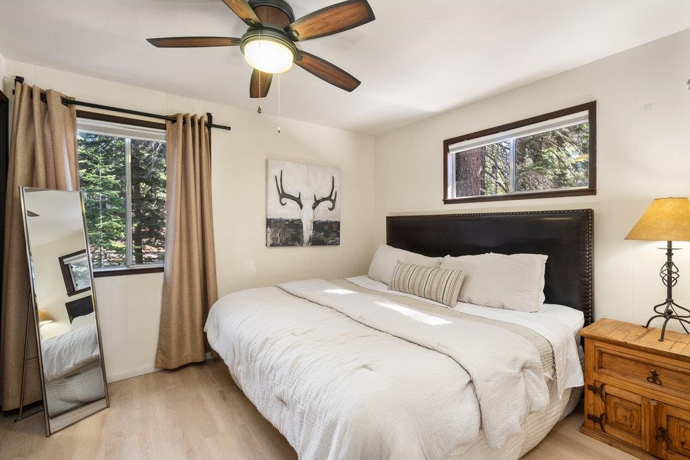 5659 Rhodesia Road Carnelian Bay, CA 96140 - Photo 18 of 28 a bedroom with a large bed and a window