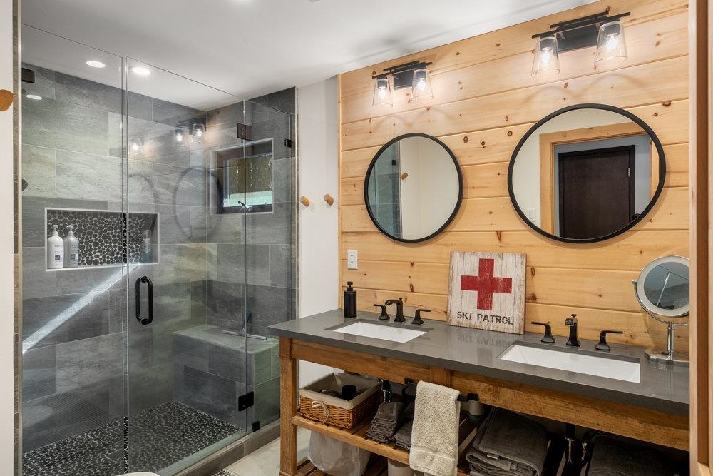5659 Rhodesia Road Carnelian Bay, CA 96140 - Photo 19 of 28 a bathroom with a double vanity sink and a mirror