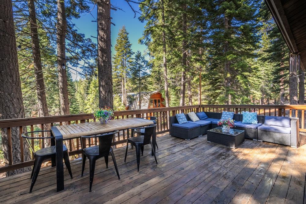 5659 Rhodesia Road Carnelian Bay, CA 96140 - Photo 22 of 28 a backyard of a house with table and chairs