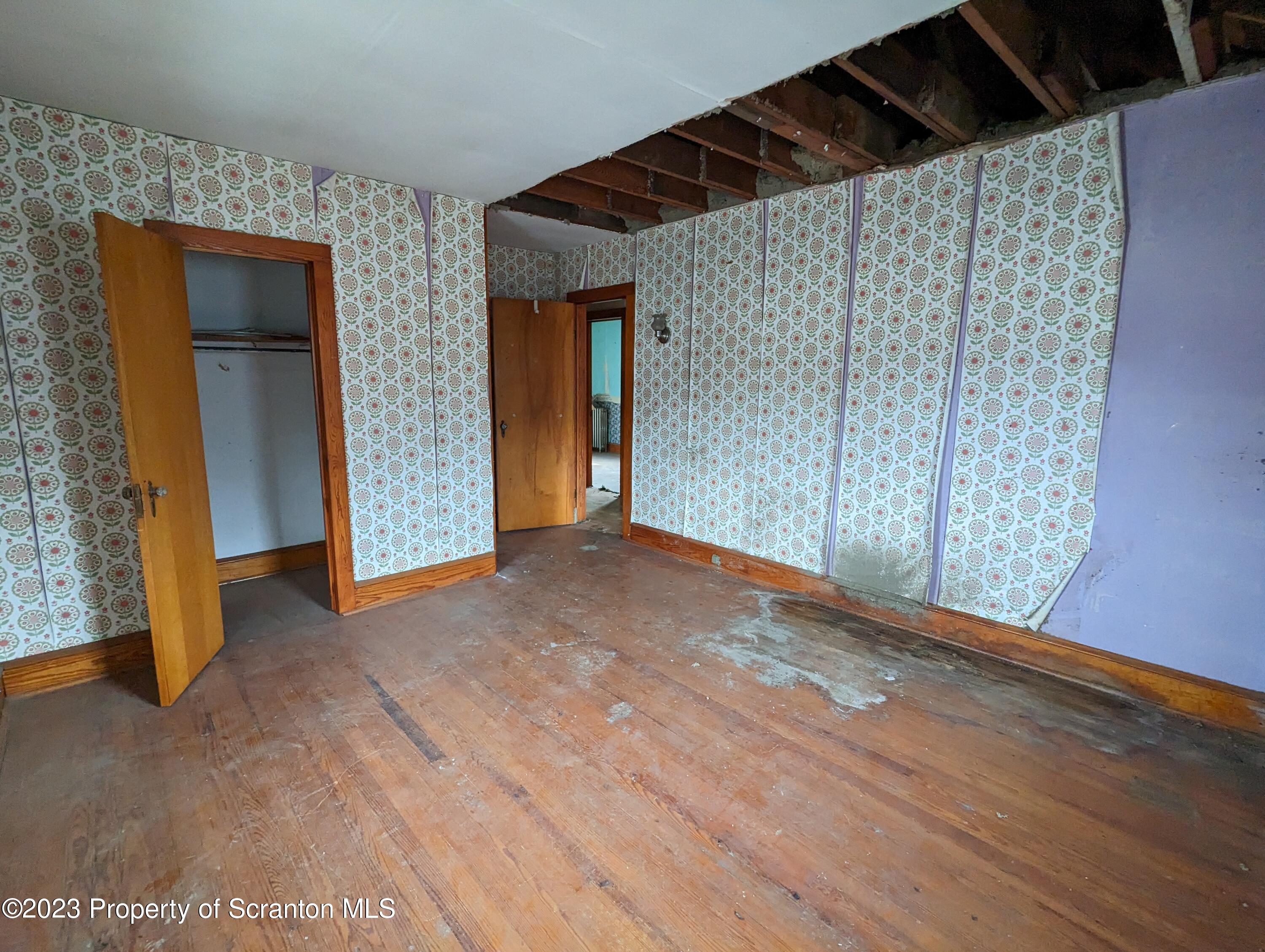 710 Edgebrook Drive Moosic, PA 18507 - Photo 16 of 19 a view of an empty room with wooden floor and closet