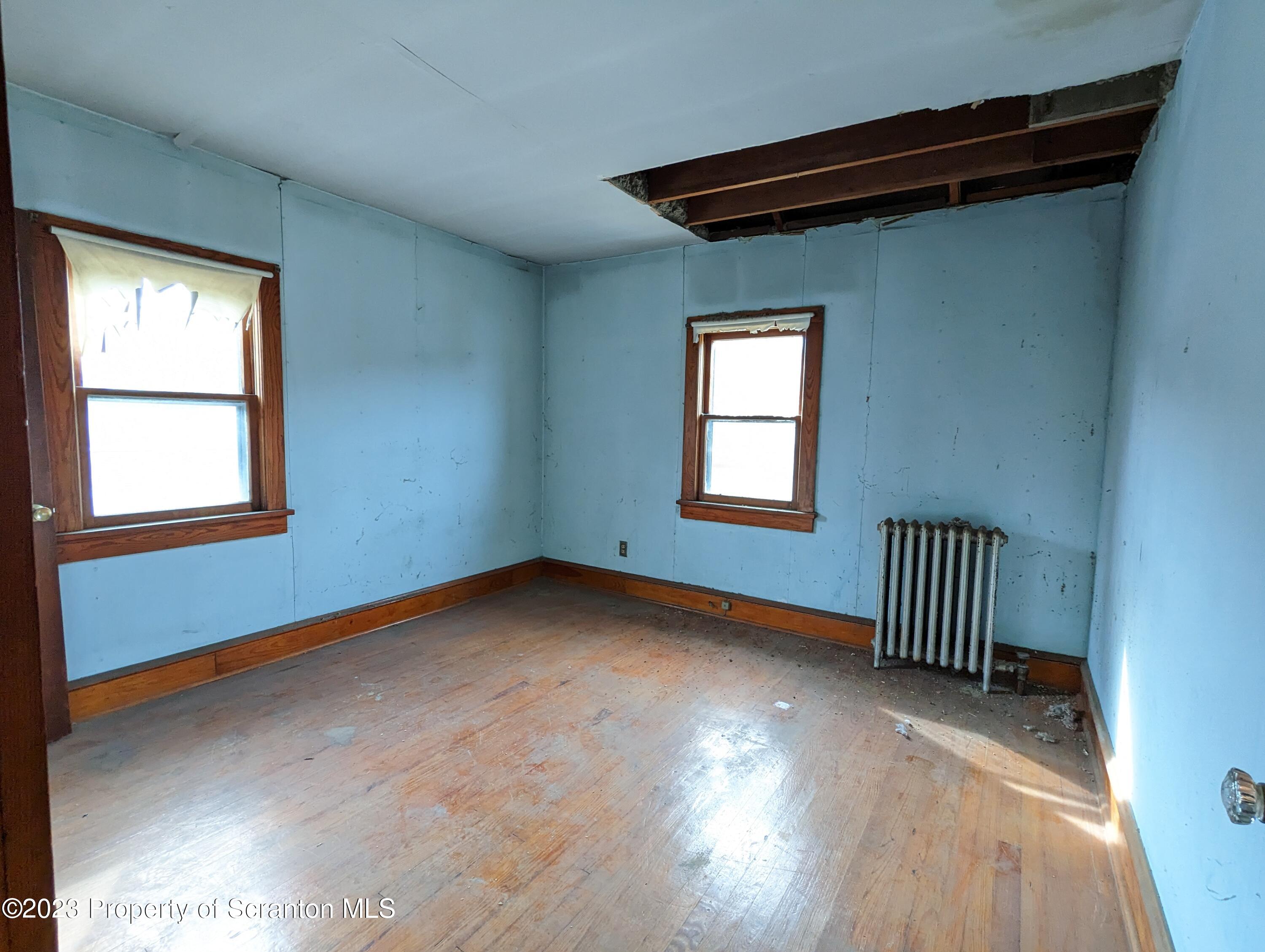 710 Edgebrook Drive Moosic, PA 18507 - Photo 17 of 19 a view of an empty room with wooden floor and a window