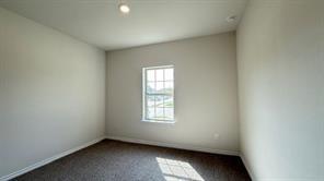 4304 Placer Mine Road Aubrey, TX 76227 - Photo 3 of 12 Neutral-toned walls complement the dark carpeting in this interior space