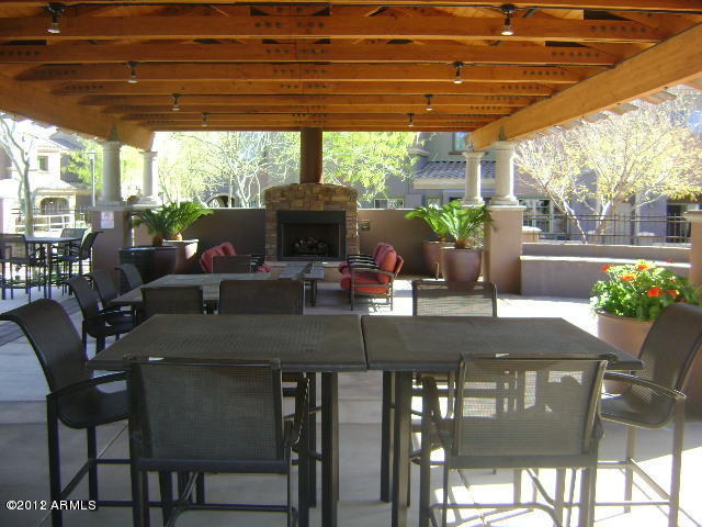 3935 East Rough Rider Road, Unit 1198 Phoenix, AZ 85050 - Photo 22 of 23 POOL SITTING AREA WITH FIREPLACE