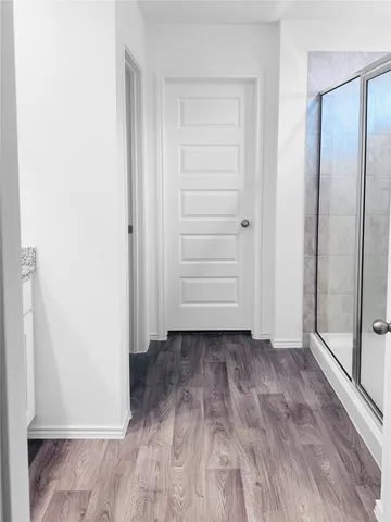 a view of a room with wooden floor