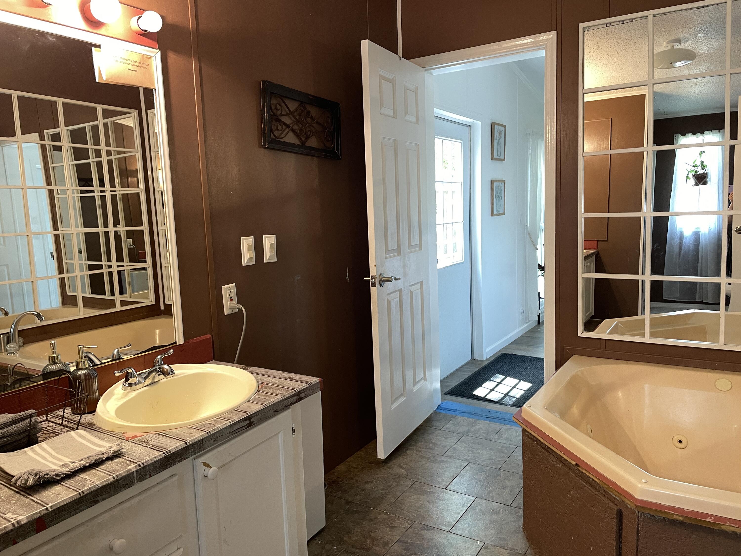 2166 Healing Springs Road Blackville, SC 29817 - Photo 16 of 43 a bathroom with a granite countertop sink and a mirror