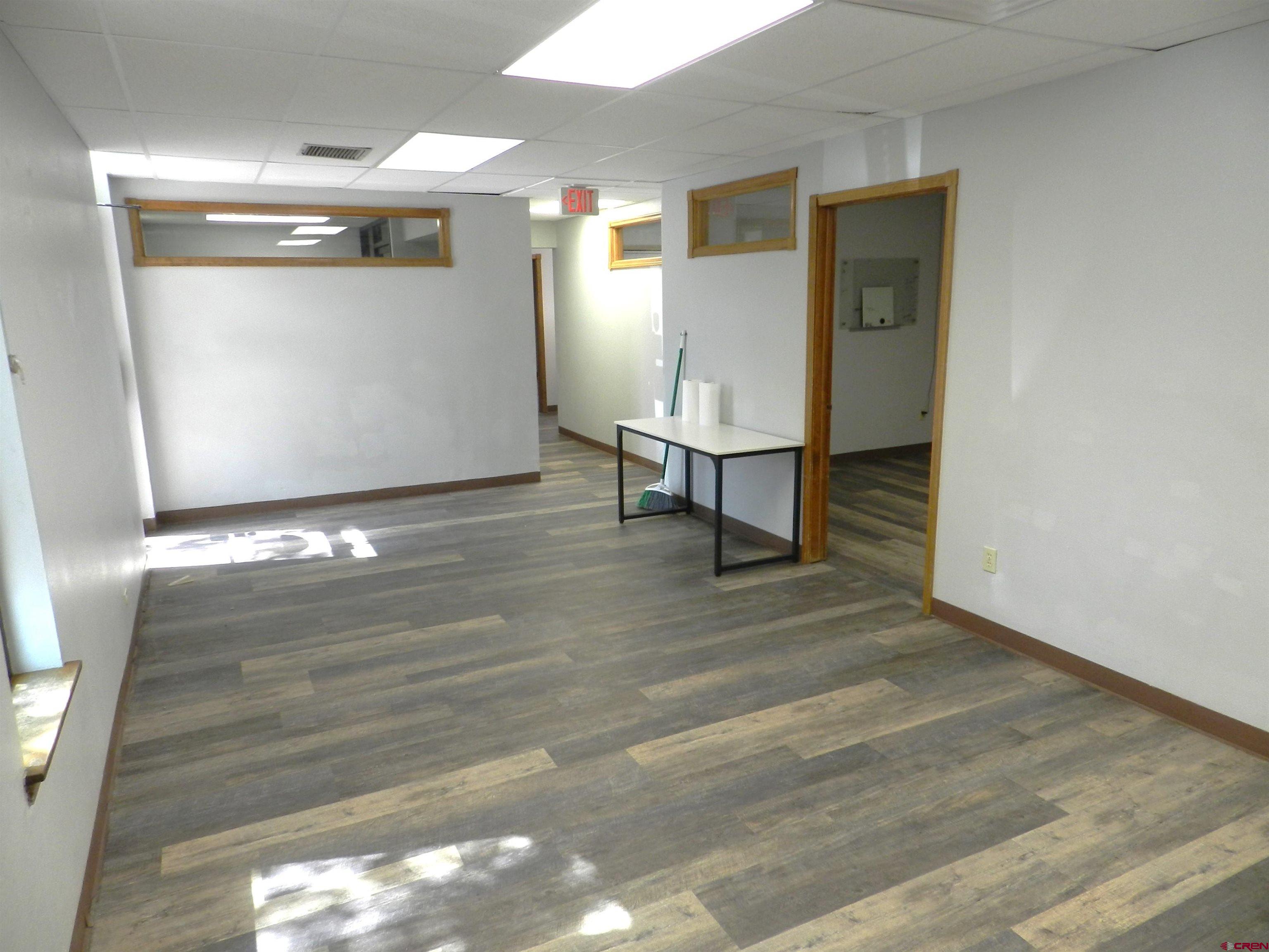 18 North Uncompahgre Avenue, Unit BACK SECTION OF 501 E MAIN BUILDING Montrose, CO 81401 - Photo 5 of 24 a view of a hallway with wooden floor and dining room