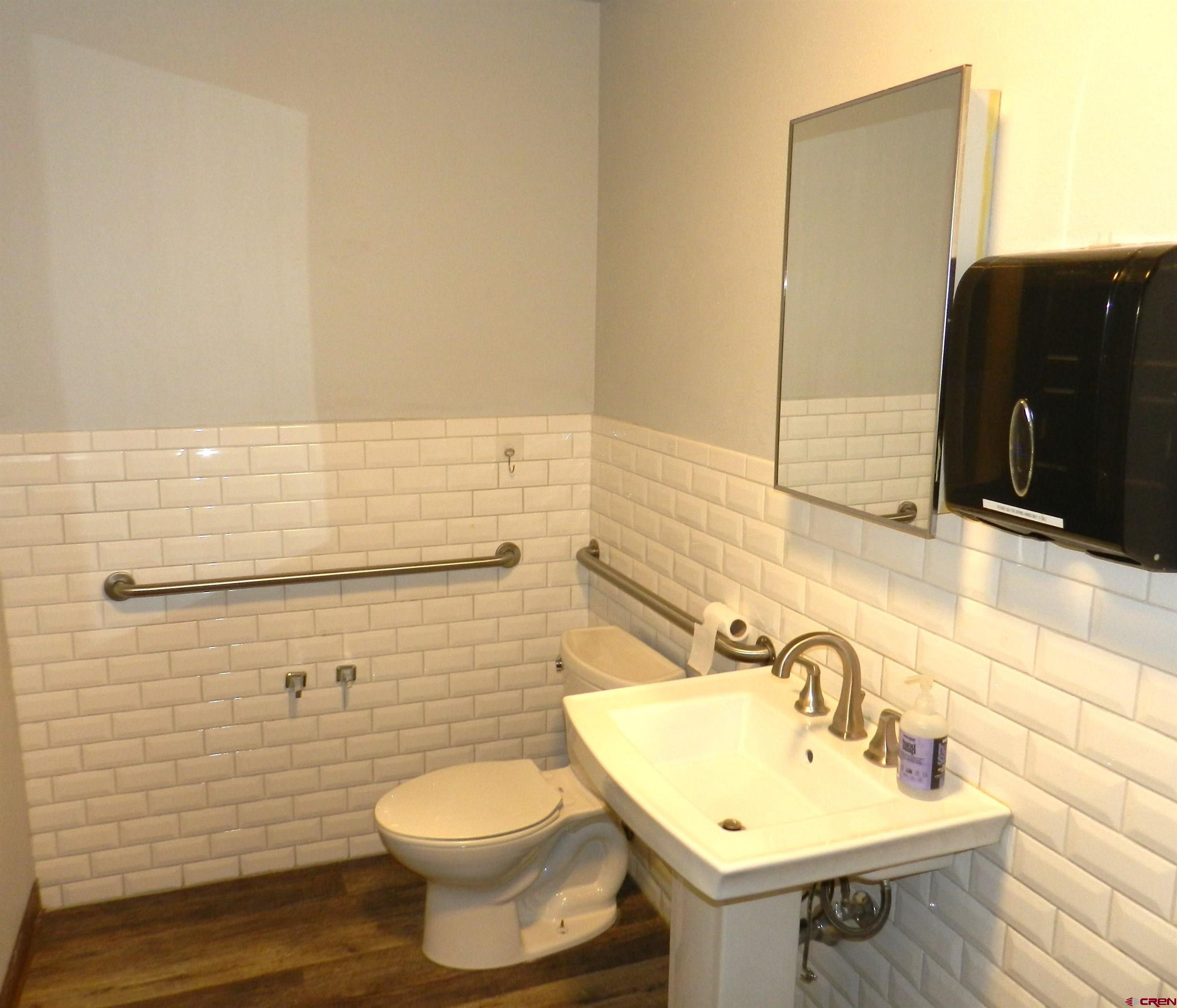 18 North Uncompahgre Avenue, Unit BACK SECTION OF 501 E MAIN BUILDING Montrose, CO 81401 - Photo 9 of 24 a bathroom with a sink toilet and mirror