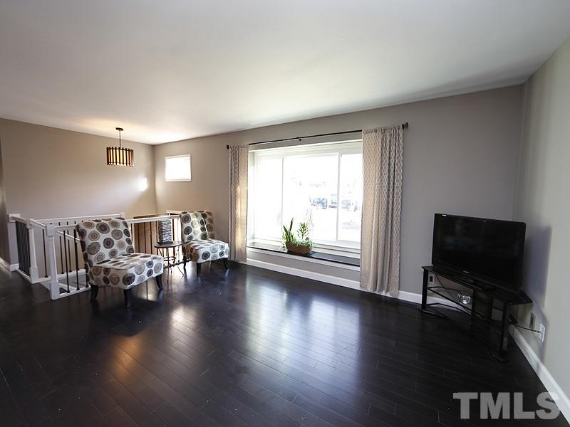 7209 Fiesta Way Raleigh, NC 27615 - Photo 2 of 24 a living room with furniture and a flat screen tv
