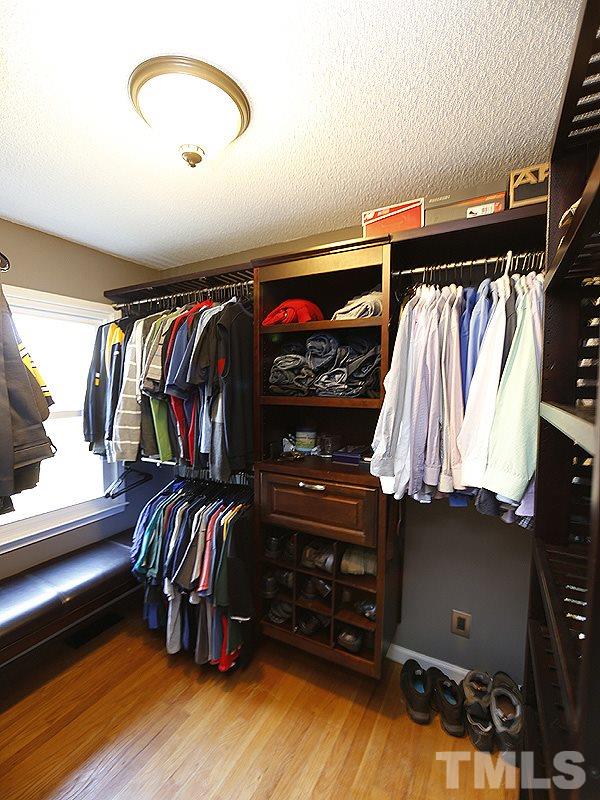 7209 Fiesta Way Raleigh, NC 27615 - Photo 11 of 24 a view of walk in closet with clothes and shoes