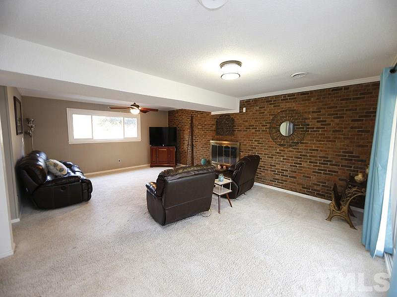 7209 Fiesta Way Raleigh, NC 27615 - Photo 12 of 24 a living room with furniture and a fireplace