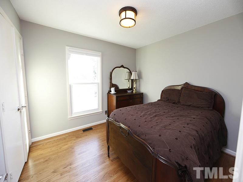 7209 Fiesta Way Raleigh, NC 27615 - Photo 14 of 24 a bedroom with a bed and a dresser