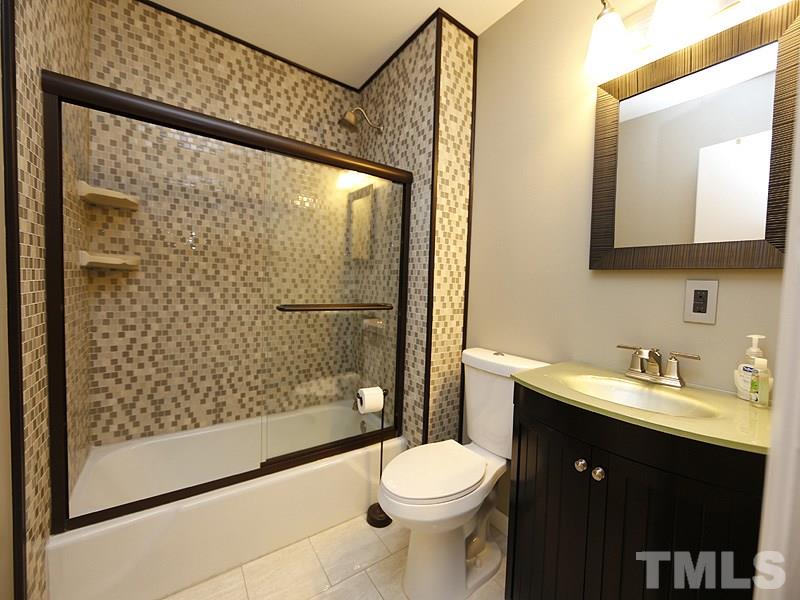 7209 Fiesta Way Raleigh, NC 27615 - Photo 15 of 24 a bathroom with a sink a toilet and shower