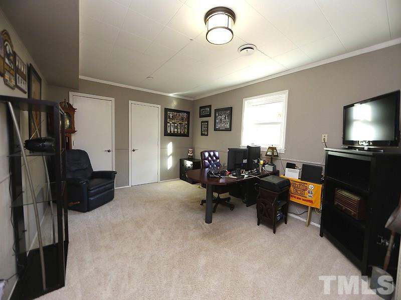 7209 Fiesta Way Raleigh, NC 27615 - Photo 16 of 24 a living room with furniture and a flat screen tv