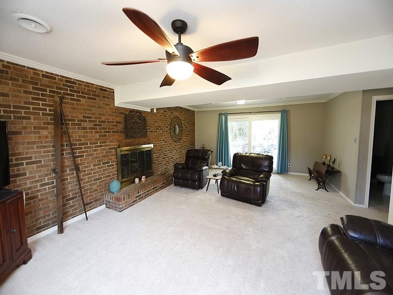7209 Fiesta Way Raleigh, NC 27615 - Photo 17 of 24 a living room with furniture and a flat screen tv