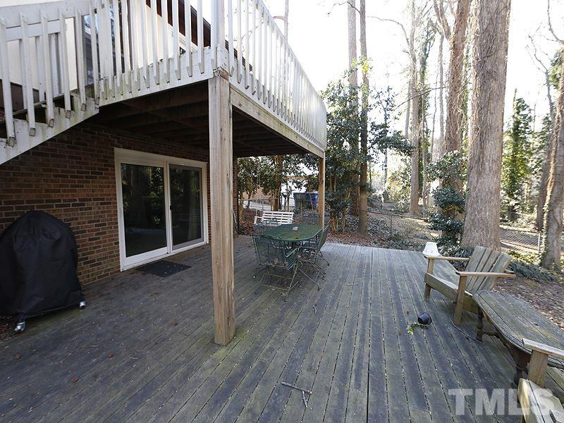 7209 Fiesta Way Raleigh, NC 27615 - Photo 22 of 24 a living room with patio fireplace and wooden floor