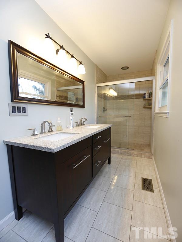7209 Fiesta Way Raleigh, NC 27615 - Photo 5 of 24 a bathroom with a sink vanity and mirror