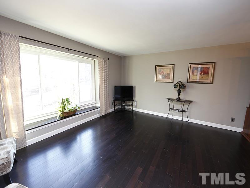 7209 Fiesta Way Raleigh, NC 27615 - Photo 6 of 24 a view of a livingroom with wooden floor and a window