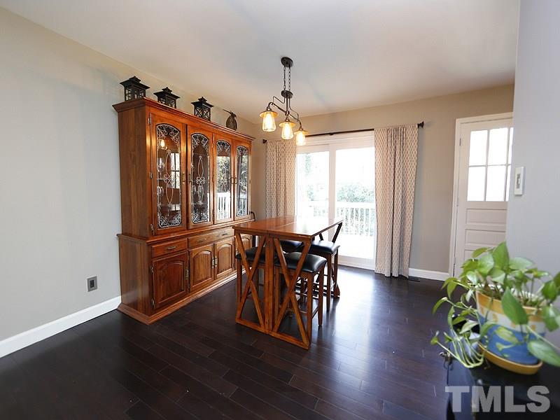 7209 Fiesta Way Raleigh, NC 27615 - Photo 8 of 24 a view of a dining room with furniture window and wooden floor