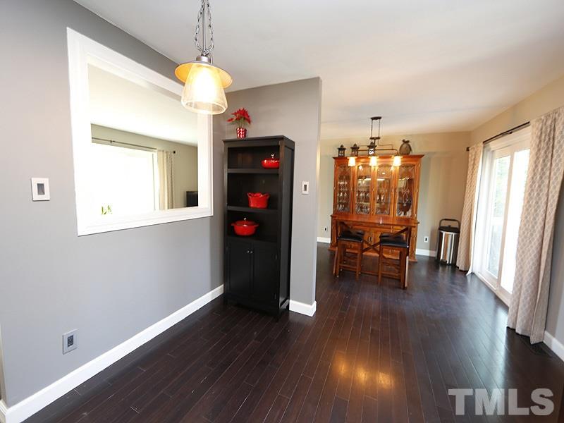 7209 Fiesta Way Raleigh, NC 27615 - Photo 10 of 24 a view of a room with wooden floor potted plant and windows