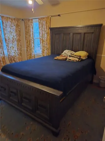 a bed sitting in a room next to a window
