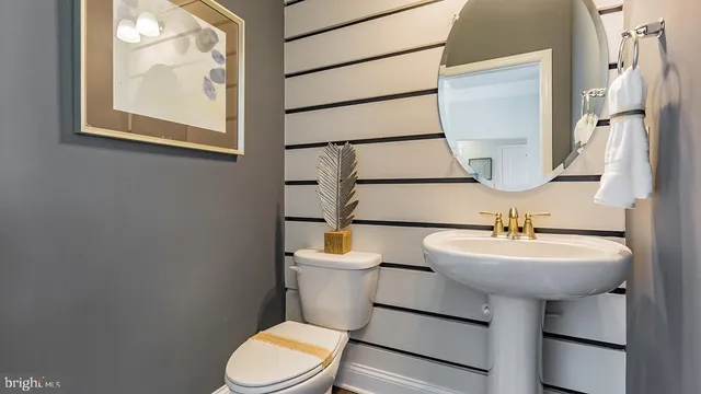 a bathroom with a sink toilet and mirror