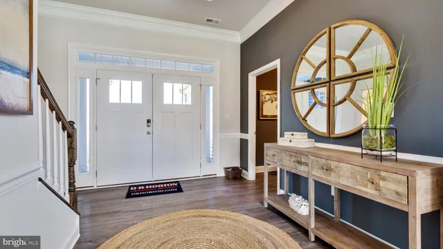 a living room with stainless steel appliances furniture a fireplace and a large window