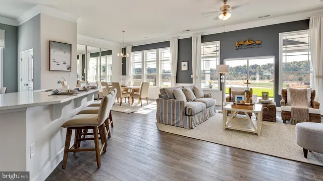 a living room with furniture and large windows