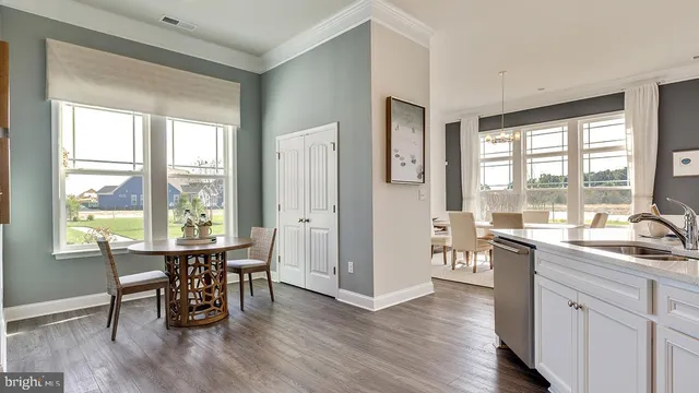 a view of a kitchen with dining table and chairs