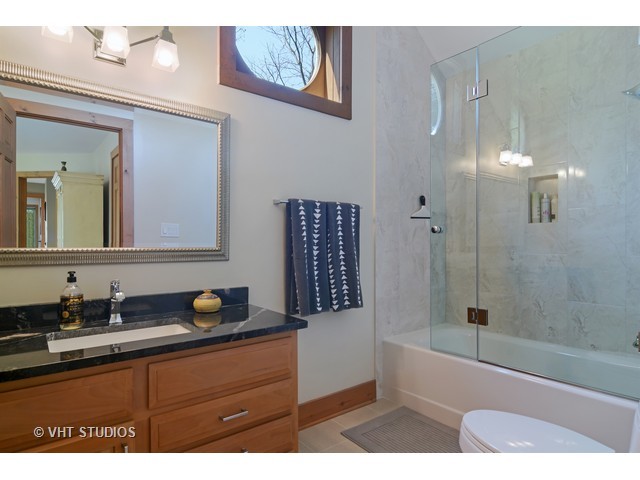5727 Hampton Drive Long Grove, IL 60047 - Photo 16 of 25 a bathroom with a sink a mirror a bathtub and shower