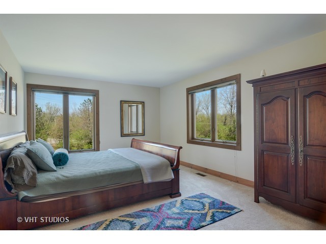 5727 Hampton Drive Long Grove, IL 60047 - Photo 18 of 25 a bedroom with a bed next to a window with outer view