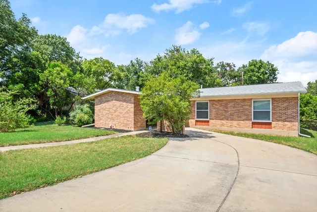 a front view of a house with a yard and a garage