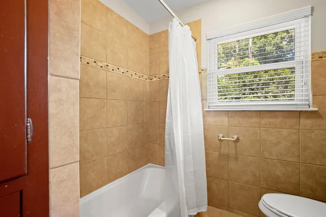 a bathroom with a toilet and shower