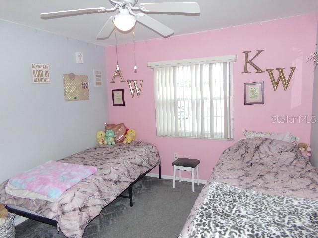 7630 Balharbour Drive New Port Richey, FL 34653 - Photo 13 of 17 a bedroom with a bed chandelier and a window