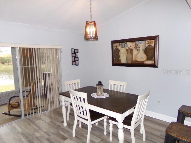 7630 Balharbour Drive New Port Richey, FL 34653 - Photo 6 of 17 a view of a dining room with furniture window and wooden floor