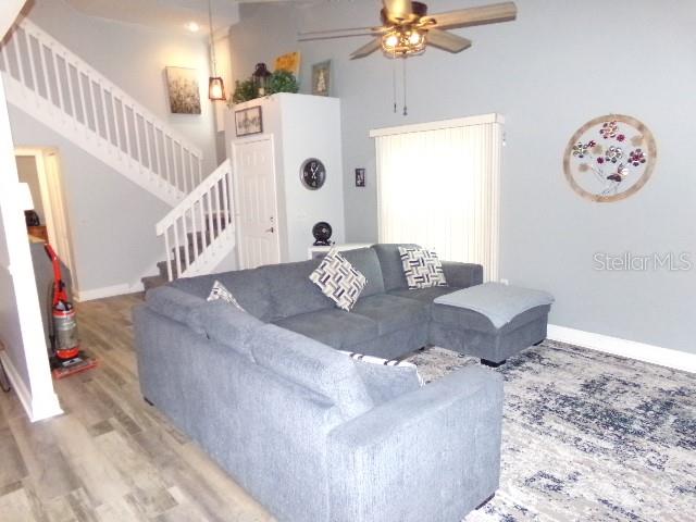 7630 Balharbour Drive New Port Richey, FL 34653 - Photo 7 of 17 a living room with furniture and a chandelier