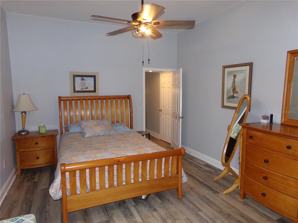 7630 Balharbour Drive New Port Richey, FL 34653 - Photo 10 of 17 a bedroom with furniture and a mirror