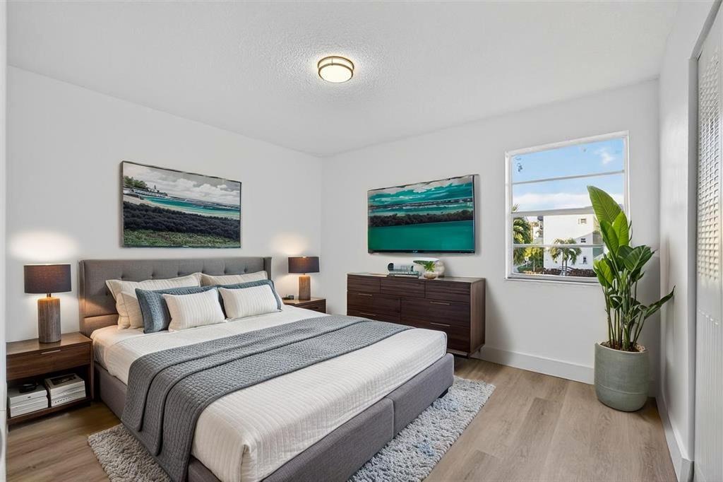2465 Southwest 18th Avenue, Unit 3206 Miami, FL 33133 - Photo 13 of 19 a bedroom with a bed and a flat screen tv