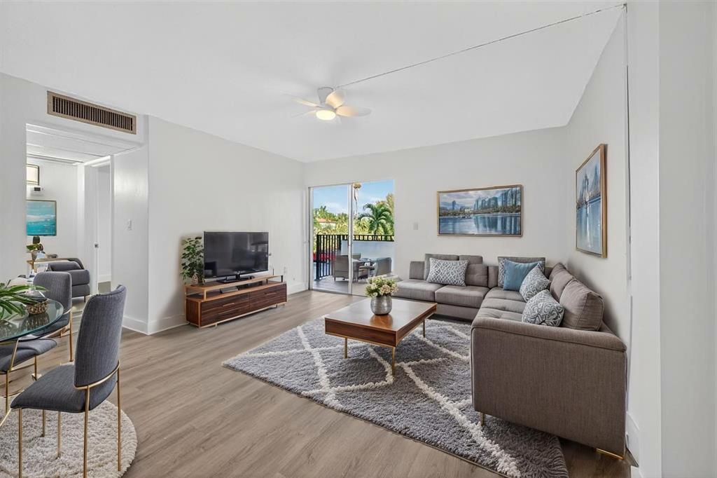 2465 Southwest 18th Avenue, Unit 3206 Miami, FL 33133 - Photo 3 of 19 a living room with furniture and a flat screen tv