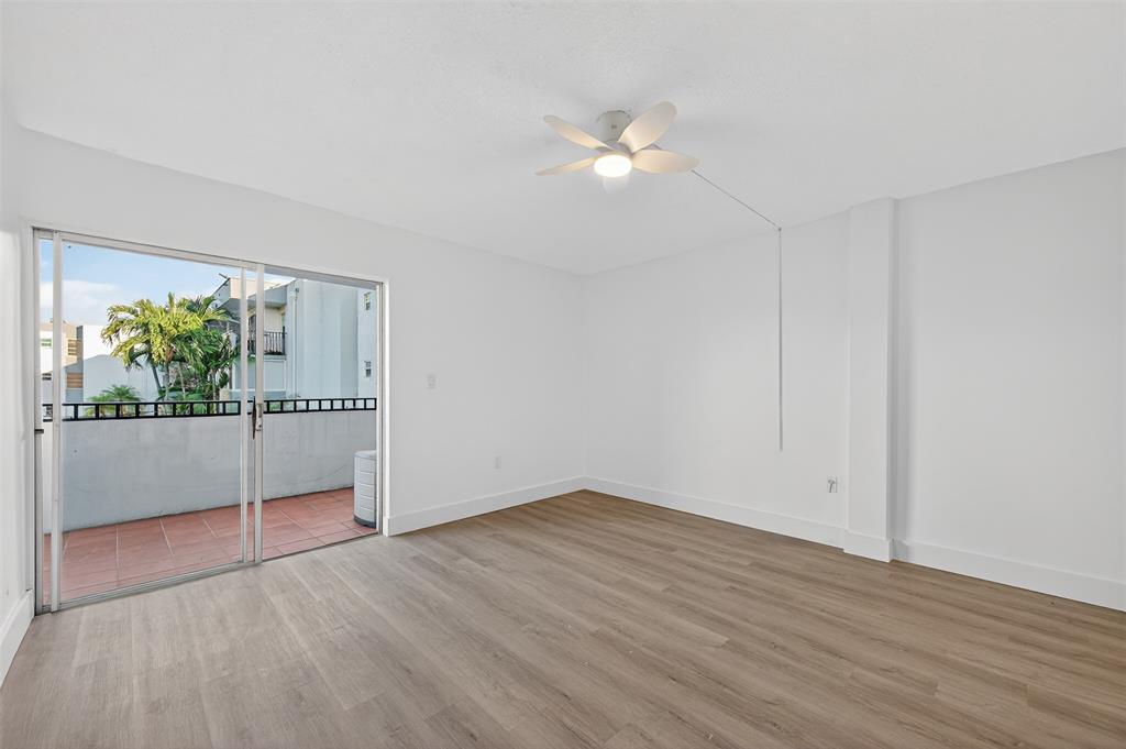 2465 Southwest 18th Avenue, Unit 3206 Miami, FL 33133 - Photo 5 of 19 a view of empty room with wooden floor and fan