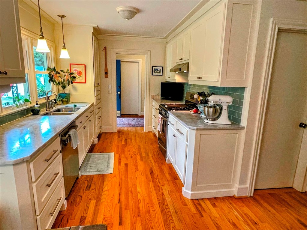 103 Poole Lane Clemson, SC 29631 - Photo 11 of 48 Glass subway tiles on the back splash are a serene seafoam color.