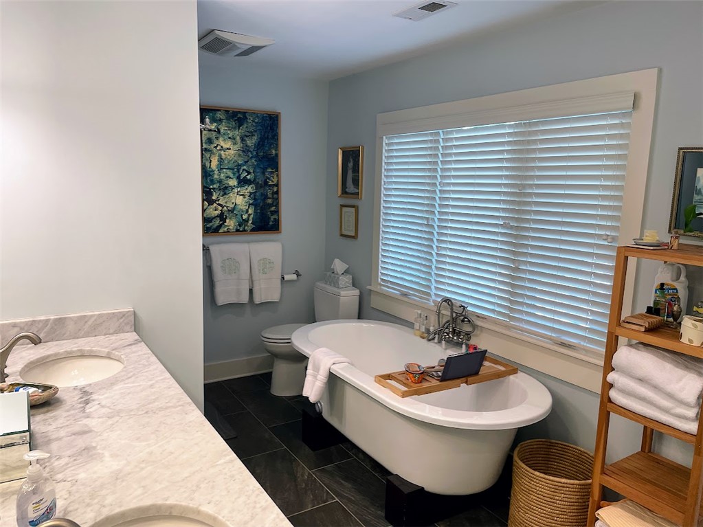 103 Poole Lane Clemson, SC 29631 - Photo 20 of 48 This bathroom features a double vanity and a luxurious soaking tub for ultimate relaxation. The endless hot water heater means you can soak for as long as you would like!