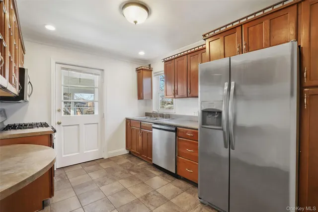a kitchen with stainless steel appliances granite countertop a refrigerator and a stove top oven