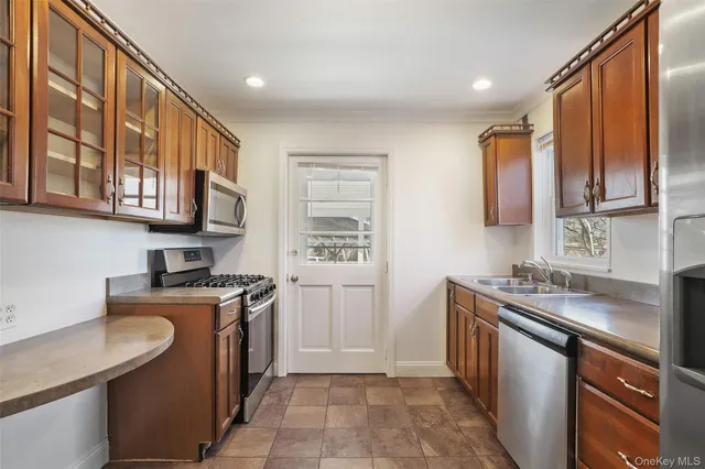a kitchen with stainless steel appliances granite countertop a sink stove and cabinets