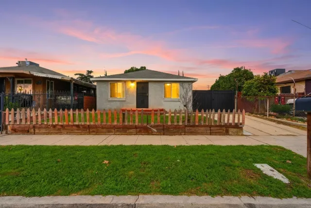 a front view of a house with a yard table and chairs
