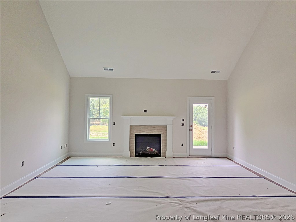 2678 Norrington Road Lillington, NC 27546 - Photo 11 of 31 a view of an empty room with a fireplace and a window