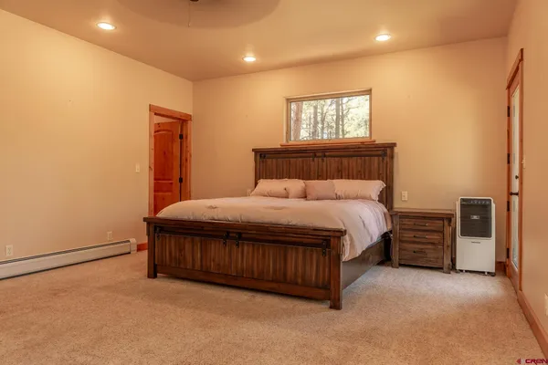 a bedroom with furniture and a chandelier