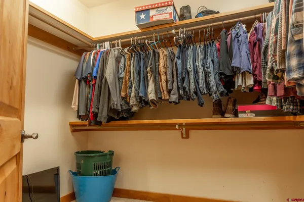 a bedroom with furniture and a flat screen tv