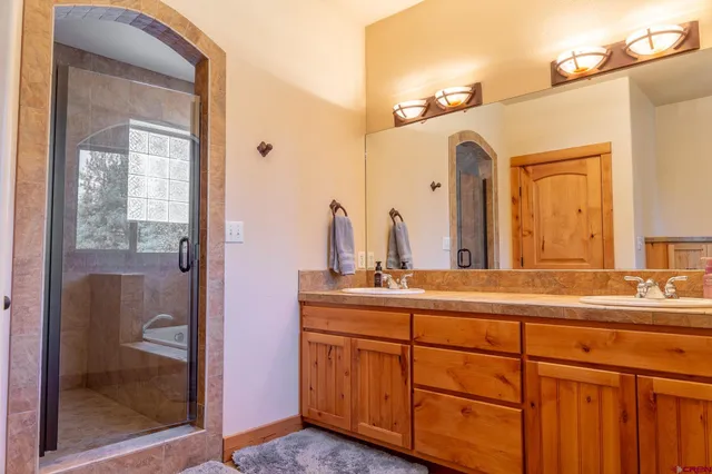 a bathroom with a double vanity sink and a mirror