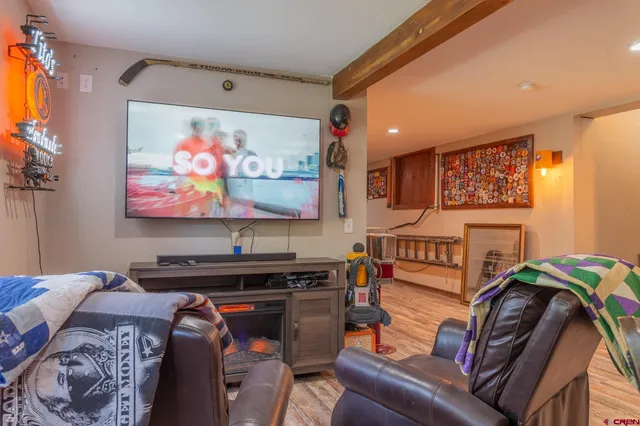 a bedroom with furniture and a flat screen tv